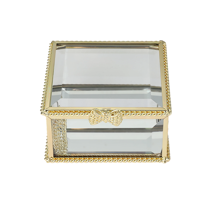 Glass jewelry box with gold decorative frame on a white background