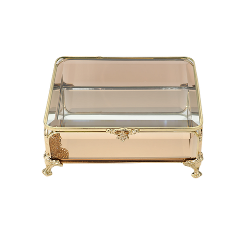 Decorative glass box with gold accents on a white background