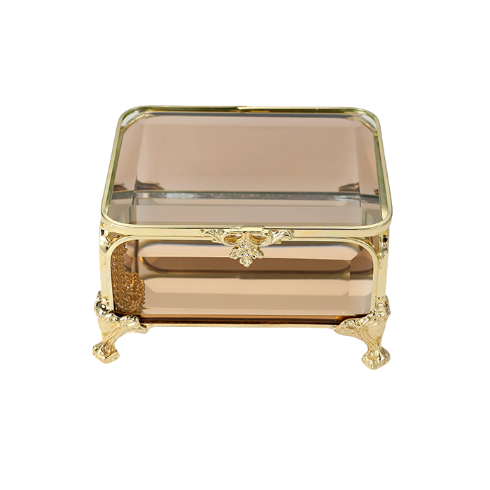 Decorative glass box with gold frame and legs on a white background