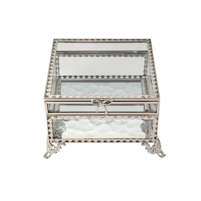 Decorative glass box with metal frame and bow on a white background
