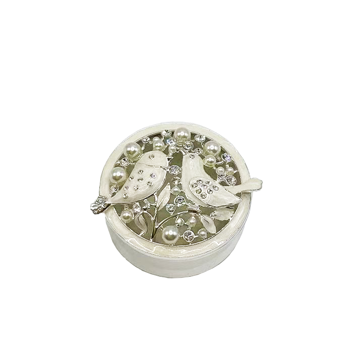 Decorative jewelry box with birds and pearls on a white background