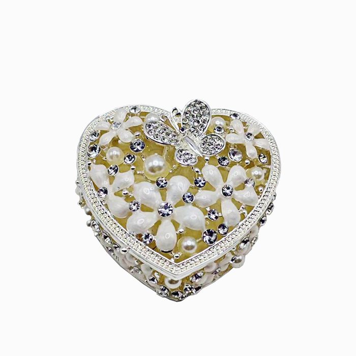 Decorative heart-shaped box with flowers and a butterfly on a white background