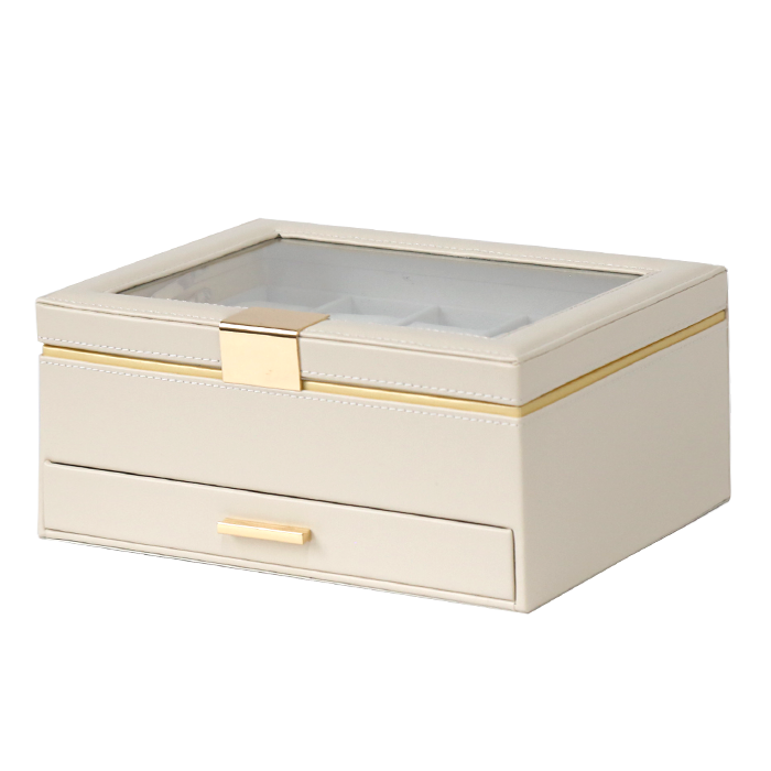 Beige jewelry box with a glass top and gold accents on a white background