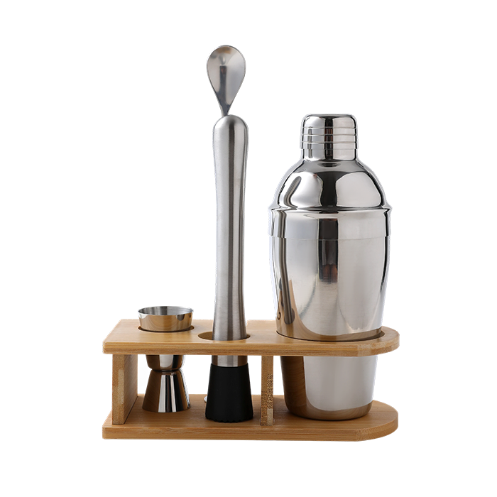 Set of cocktail-making tools including a shaker, jigger, and spoon on a wooden stand with a white background.